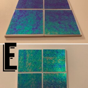 May include: Set of four iridescent blue and green square tiles. The tiles are arranged in a 2x2 grid.