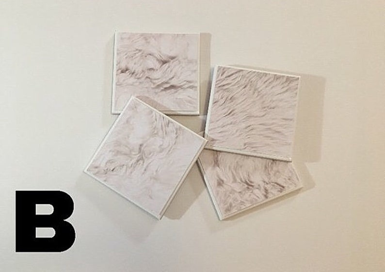 May include: Four square white coasters with a faux fur texture. The coasters are arranged in a pile.