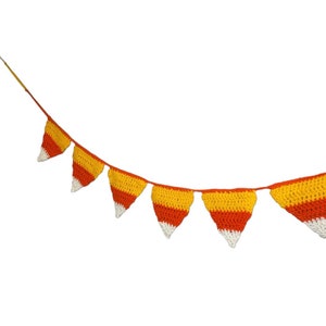May include: A crocheted banner featuring triangular pennants in the colors of candy corn: white, yellow, and orange. The pennants are strung together on a thin orange cord, creating a festive decoration.