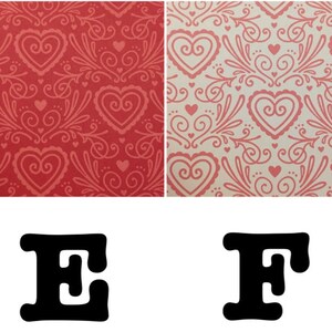 May include: Two red and white patterned paper sheets with the letters E and F in black.