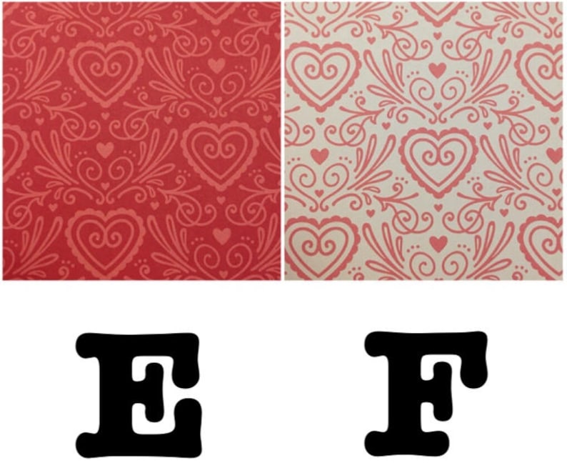 May include: Two red and white patterned paper sheets with the letters E and F in black.