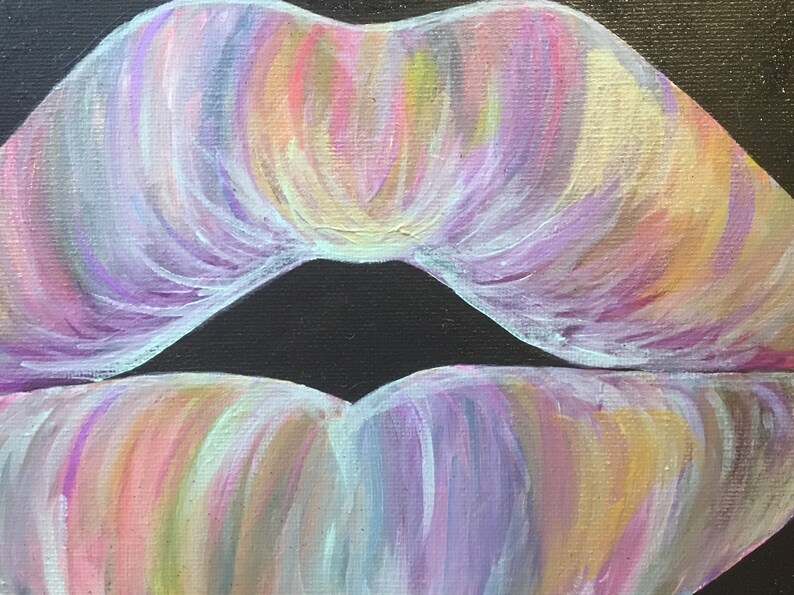 May include: An acrylic painting on canvas depicting a pair of lips rendered in a blend of pastel colors including lavender, soft pink, pale yellow, and light blue. The brushstrokes are visible, creating a textured effect against a solid black background.