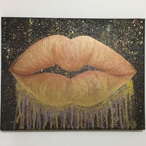 Pu&ograve; includere: Un primo piano di un dipinto che raffigura un paio di labbra con uno schema di colori oro e arancio. Le labbra sono su uno sfondo nero con macchie dorate e bianche. La parte inferiore delle labbra ha un effetto gocciolante con vernice dorata e viola.