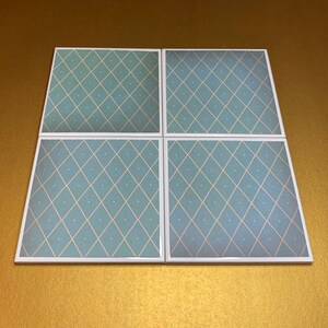May include: Set of four square ceramic coasters with a light blue and white diamond pattern.