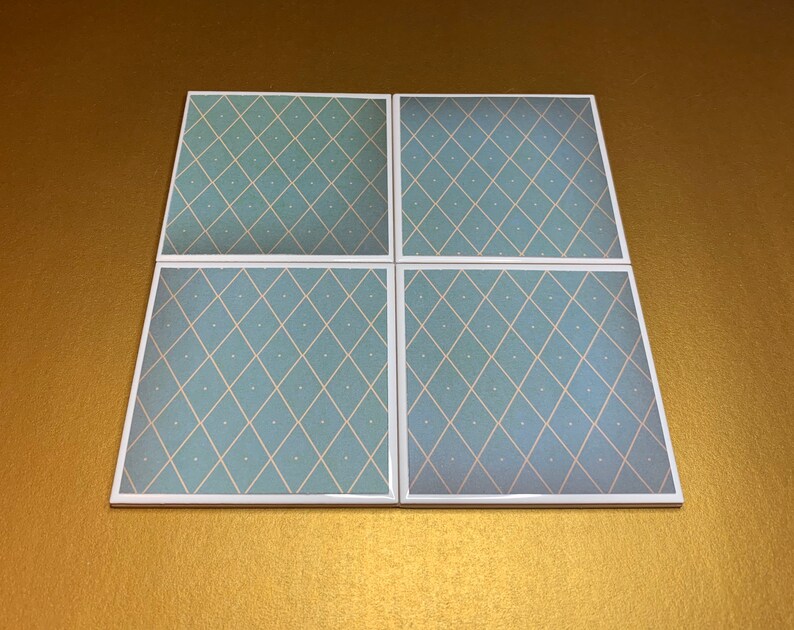 May include: Set of four square ceramic coasters with a light blue and white diamond pattern.