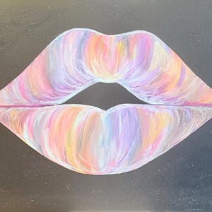 May include: A painting on a black canvas featuring a pair of lips rendered in a blend of pastel colors including pink, purple, orange, and yellow. The lips are centrally positioned against a dark background that has subtle white speckles throughout.