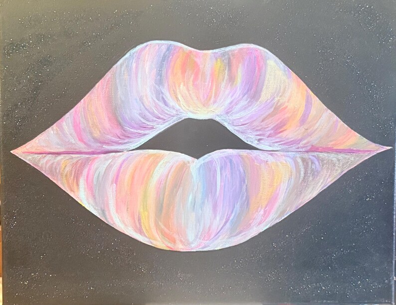 May include: A painting on a black canvas featuring a pair of lips rendered in a blend of pastel colors including pink, purple, orange, and yellow. The lips are centrally positioned against a dark background that has subtle white speckles throughout.