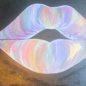 May include: A painting on a black canvas featuring a pair of lips rendered in a blend of pastel colors including light pink, lavender, soft yellow, and white. The brushstrokes are visible, creating a textured effect within the lip shape.