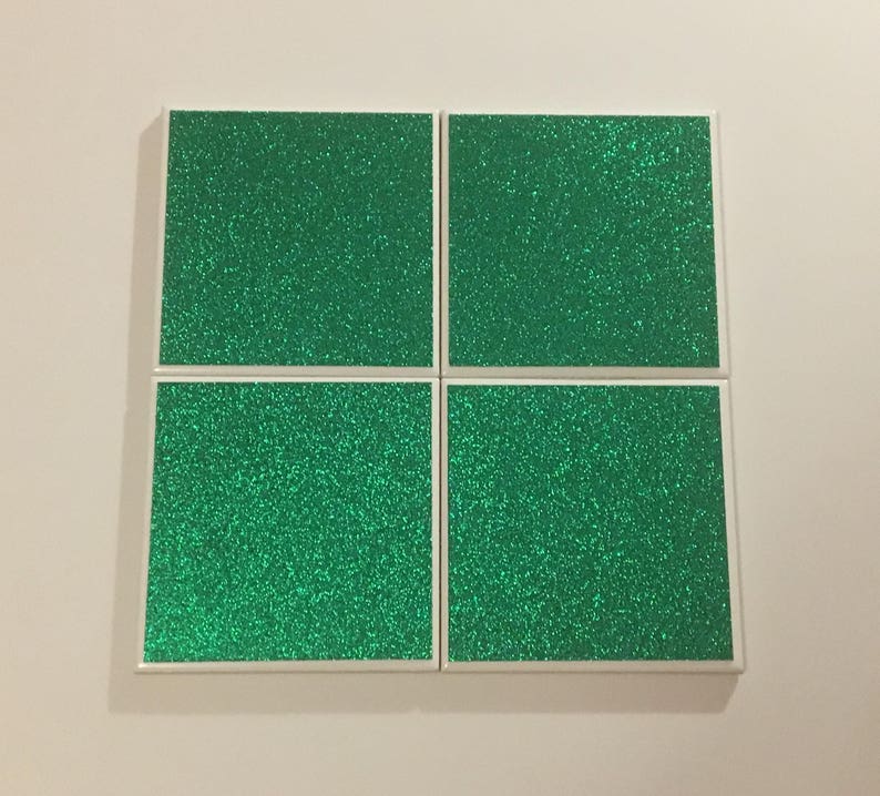 May include: Four square green glitter coasters with white borders.
