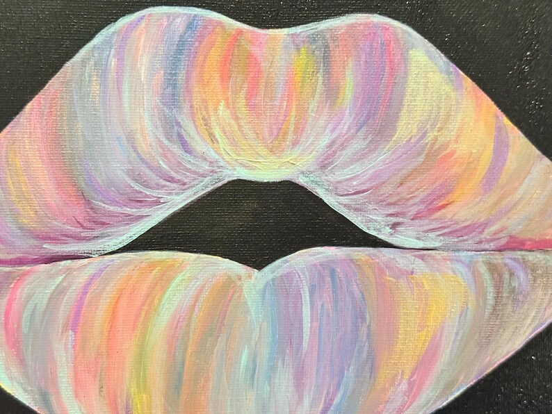 May include: An acrylic painting on canvas depicting a pair of lips centered against a solid black background. The lips are rendered with visible brushstrokes in a blend of pastel colors including light pink, lavender, yellow, and soft blue.