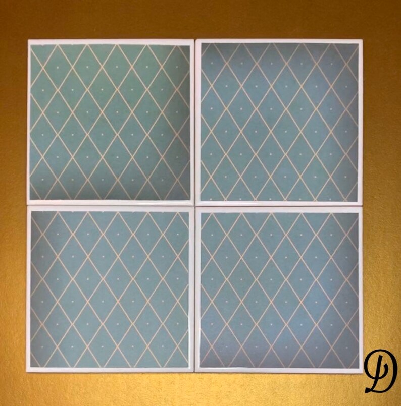 May include: Four square ceramic tiles with a light blue background and a white diamond pattern. The tiles have a white border.