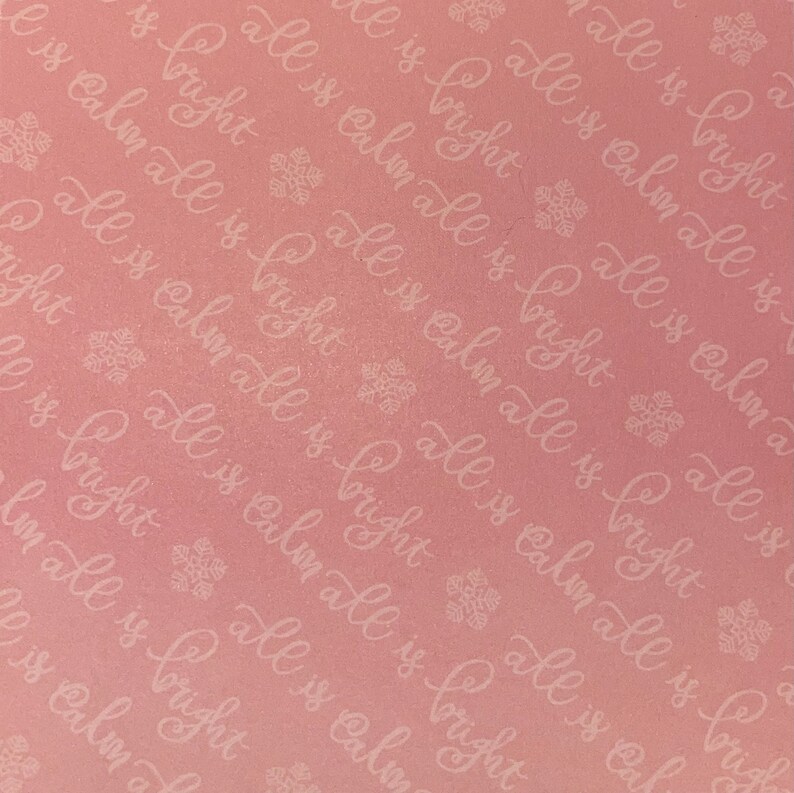 May include: A pink background with a repeating pattern of white text that says "all is calm all is bright". The text is in a cursive font and is surrounded by small snowflake designs.