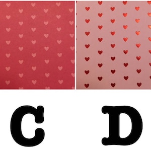 May include: Two sheets of paper with a repeating pattern of red hearts on a pink background. The letters C and D are printed in black below the sheets of paper.