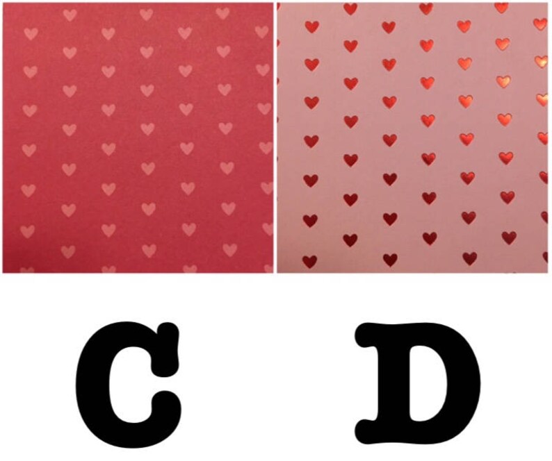 May include: Two sheets of paper with a repeating pattern of red hearts on a pink background. The letters C and D are printed in black below the sheets of paper.