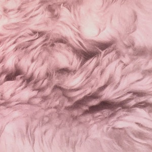 May include: A close-up of a soft, pink, fluffy fabric with a textured, wavy pattern.