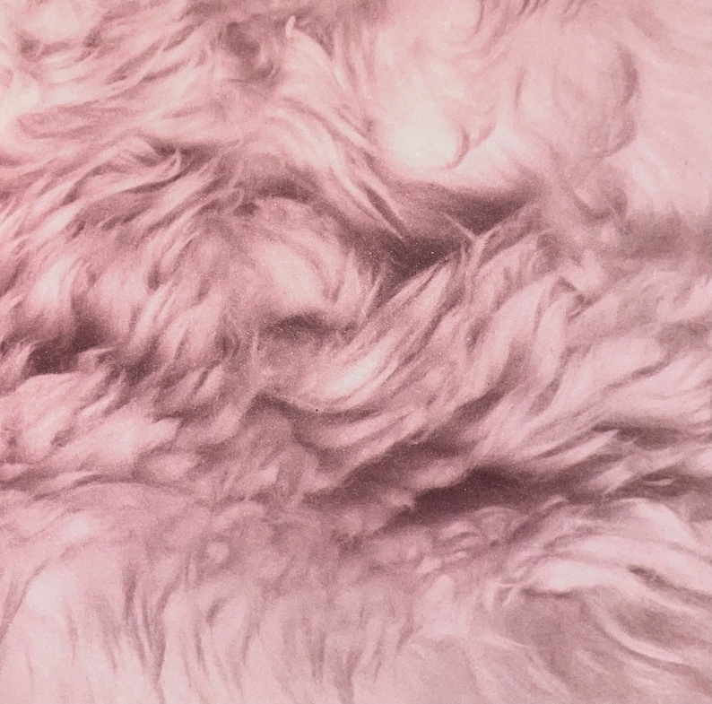 May include: A close-up of a soft, pink, fluffy fabric with a textured, wavy pattern.