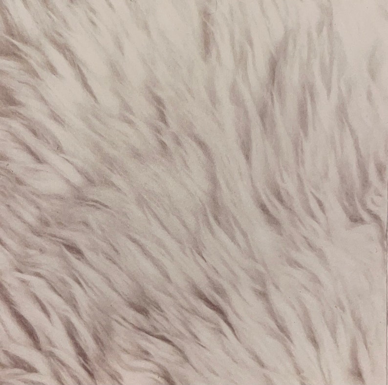 May include: A close-up of a white faux fur rug with a soft, fluffy texture.