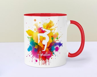 May include: White ceramic mug with a red rim and handle. The mug features a colourful watercolour design of a gymnast in a handstand pose with the name "Amelia" printed below.