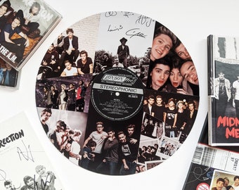 May include: A white vinyl record with a collage of black and white photos of a boy band. The record is surrounded by various CDs and books with the band's name and album titles. The record has the text "LONDON FIRE" and "STEREOPHONIC" printed on it.