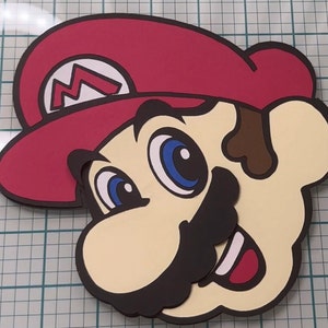 May include: A red and brown cartoon character with a red hat and a large moustache. The character has large blue eyes and a wide smile.