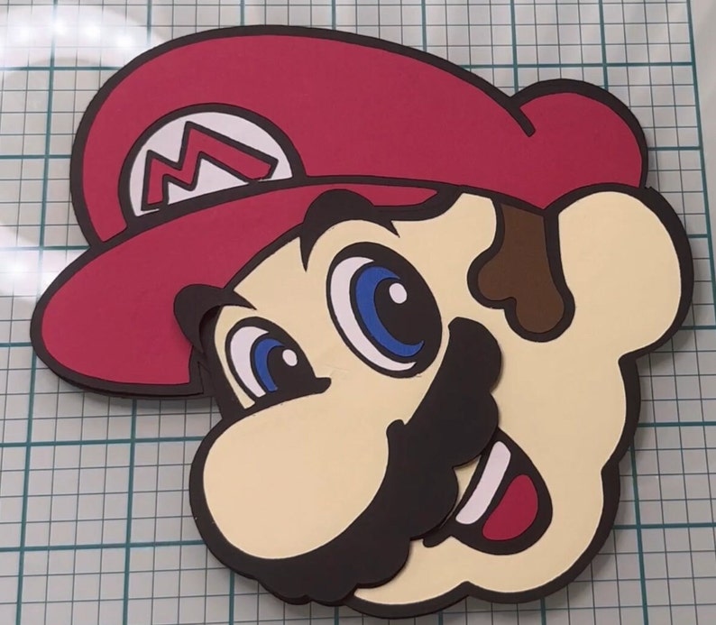 May include: A red and brown cartoon character with a red hat and a large moustache. The character has large blue eyes and a wide smile.