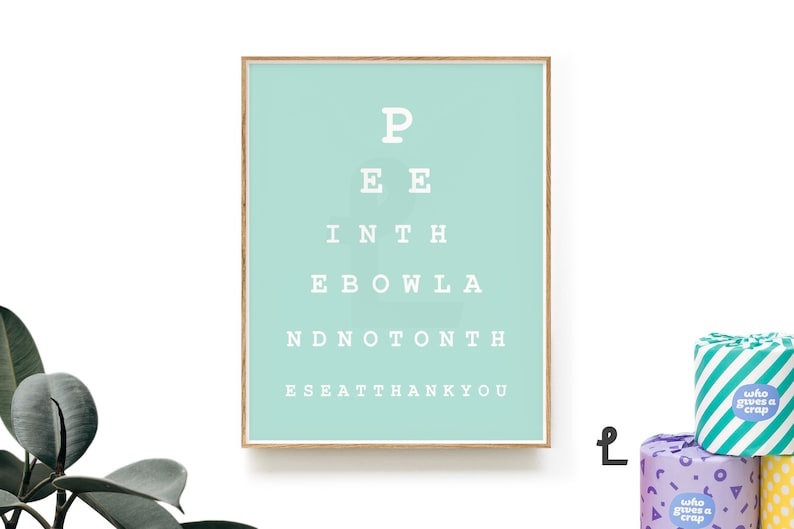 May include: A light blue framed print with a white eye chart that reads "P EE INTH EBOWLA NDNOT&Omicron;&Nu;&Tau;&Eta; ESEATTHANKYOU".