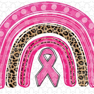 May include: Pink and brown rainbow with a pink ribbon in the center. The rainbow is made of pink stripes with white polka dots, brown and black leopard print, and pink stripes.
