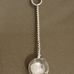 May include: A set of three ceramic mugs with a speckled, matte finish. The mugs are in shades of cream, light gray, and dark gray. Each mug has a simple, minimalist design, perfect for coffee or tea.