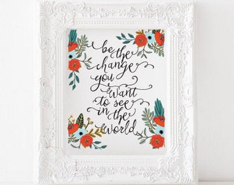 May include: White framed print with a floral design and the text "Be the change you want to see in the world".
