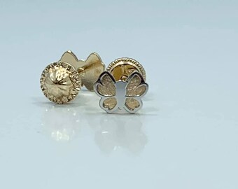 May include: A pair of gold butterfly earrings with a textured finish. The earrings are small and delicate.