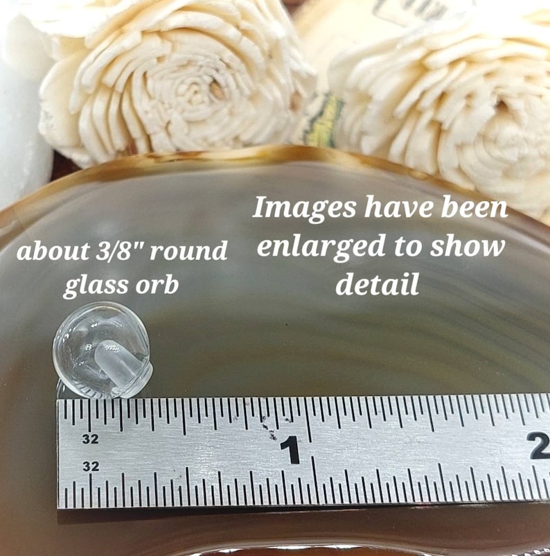 Puede incluir: Una esfera de vidrio transparente, de aproximadamente 1 cm de di&aacute;metro, con un peque&ntilde;o v&aacute;stago. El texto de la imagen dice "about 3/8" round glass orb" y "Images have been enlarged to show detail."