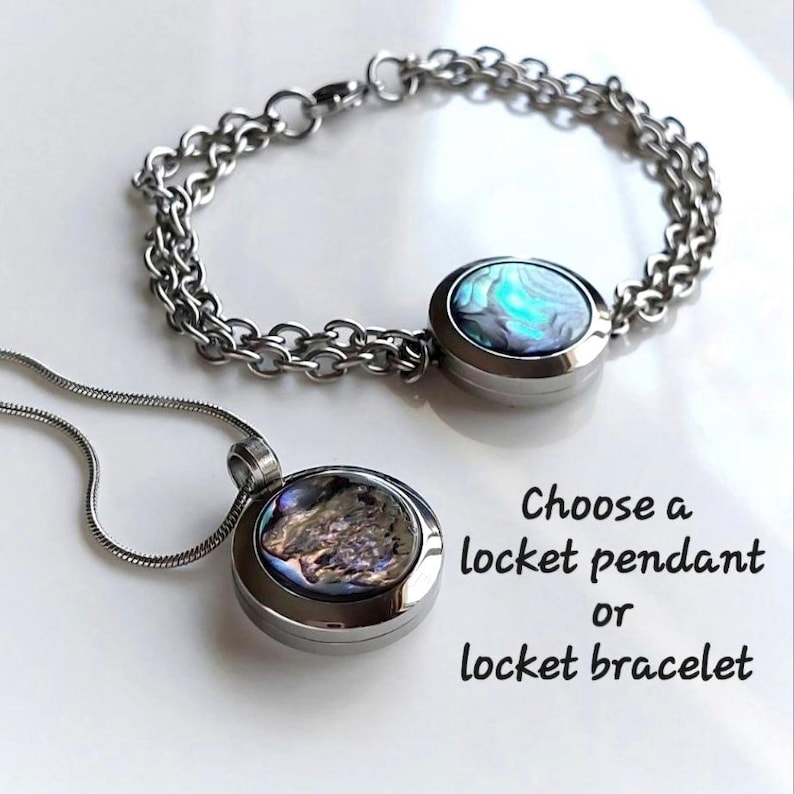 May include: A silver-toned metal locket bracelet with a round abalone shell inlay and a matching locket pendant on a thin snake chain. The text reads: Choose a locket pendant or locket bracelet. The jewelry features iridescent blue and green tones.