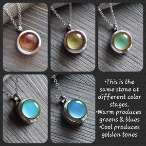 May include: Four silver necklaces with round pendants featuring a dichroic glass stone that changes color depending on the light. The stones are shown in four different color variations: gold, green, blue, and turquoise.