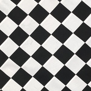 May include: Black and white checkered pattern. The pattern is made up of squares arranged in a diagonal pattern.