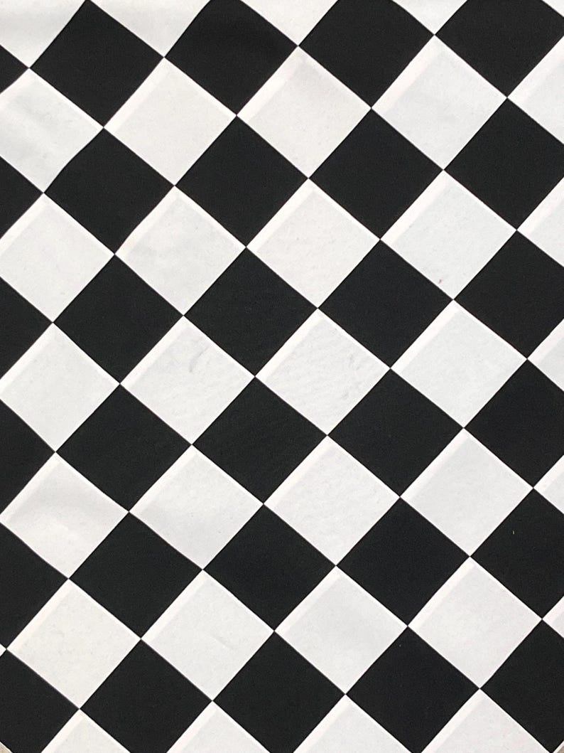 May include: Black and white checkered pattern. The pattern is made up of squares arranged in a diagonal pattern.