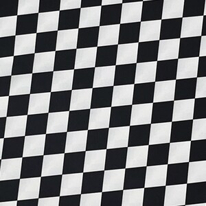 May include: Black and white checkered pattern fabric. The fabric is made of a soft, smooth material and has a subtle sheen.