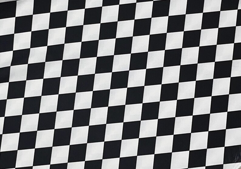 May include: Black and white checkered pattern fabric. The fabric is made of a soft, smooth material and has a subtle sheen.