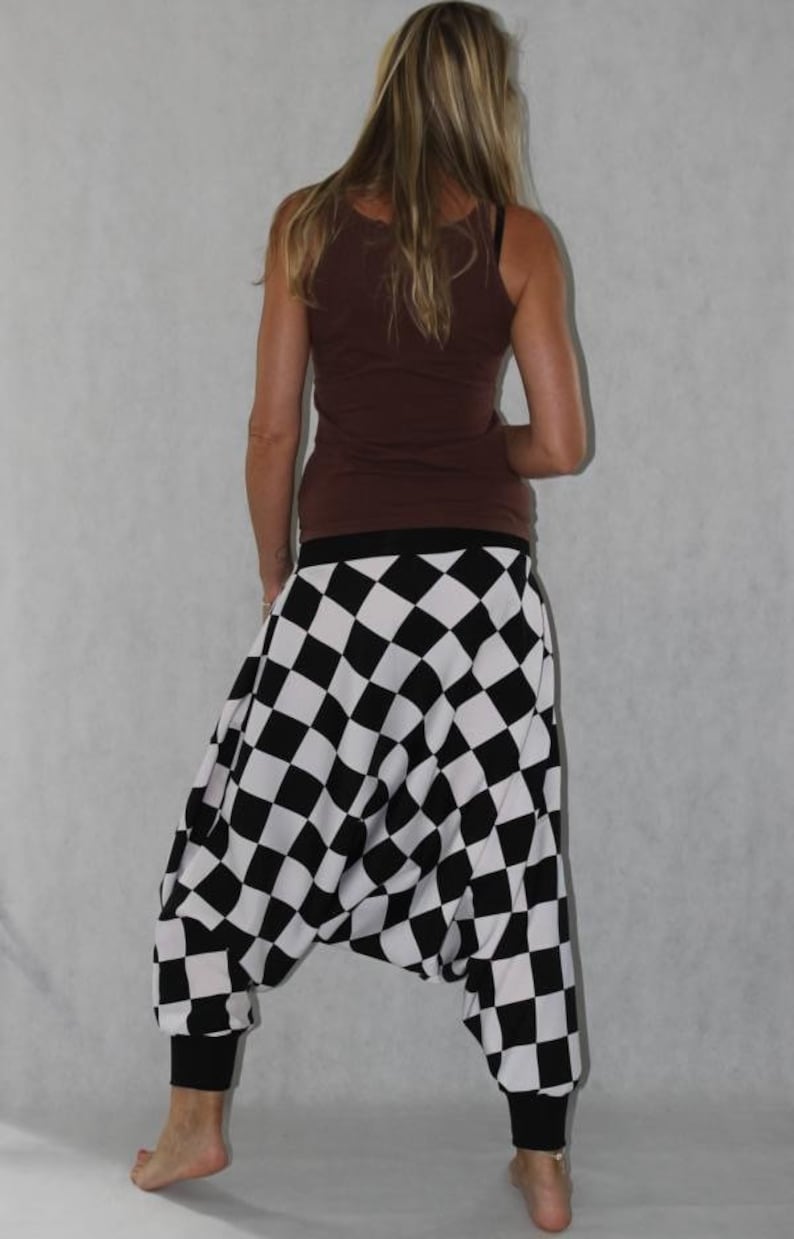 May include: Black and white checkered harem pants with a brown tank top.