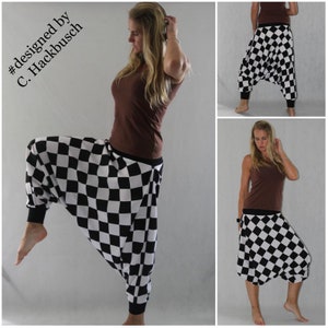 May include: Black and white checkered harem pants with a wide leg and elastic waistband. The pants are designed by C. Hackbusch.