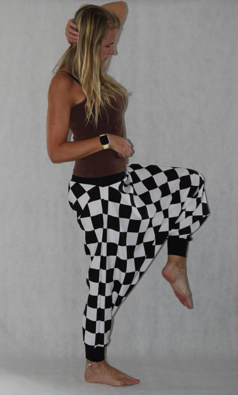 May include: Black and white checkered pants with a loose, wide-leg fit. The pants are made of a soft, comfortable fabric and have a relaxed, casual style.