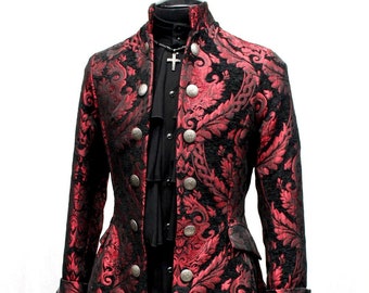 May include: A red and black brocade jacket with silver buttons. The jacket has a high collar and a long, flowing tail.