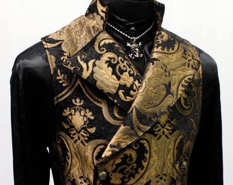 May include: A black and gold brocade vest with a double-breasted closure and a large, pointed collar. The vest has a decorative floral pattern and silver buttons.