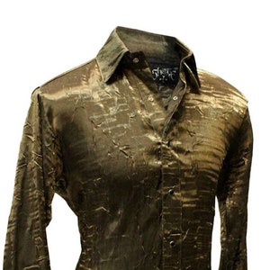 May include: A long-sleeved shirt with a textured, metallic gold fabric. The shirt has a button-up front and a collar.