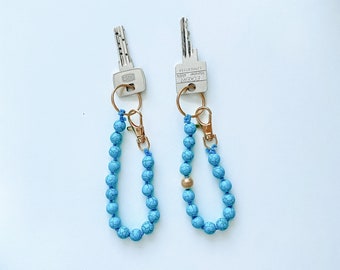 Turquoise and gold keychain with knotted beads of stabilized turquoise.