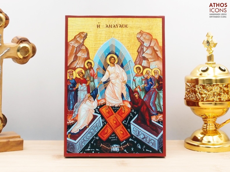 May include: A colorful icon depicting the resurrection of Jesus Christ. The icon features Jesus ascending from a tomb, surrounded by figures, with the Greek text "&Eta; &Alpha;&Nu;&Alpha;&Sigma;&Tau;&Alpha;&Sigma;&Iota;&Sigma;" at the top.