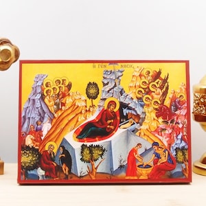 May include: A colourful religious icon depicting the Nativity of Jesus. The icon features a central scene of Mary and the baby Jesus in a cave, surrounded by angels and shepherds. The icon is painted in a traditional style with vibrant colours and intricate details. The text "Η ΤΟΝ ΝΥΧΙ" is written at the top of the icon.