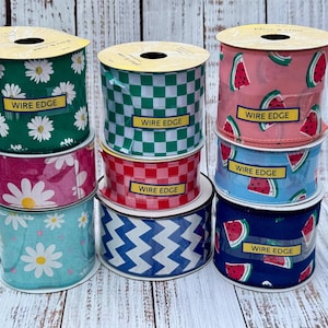 May include: Eight rolls of wired edge ribbon with various summery patterns. The patterns include daisies, checkered, watermelon, and zigzags. Each roll has a yellow label that says "Wire Edge".