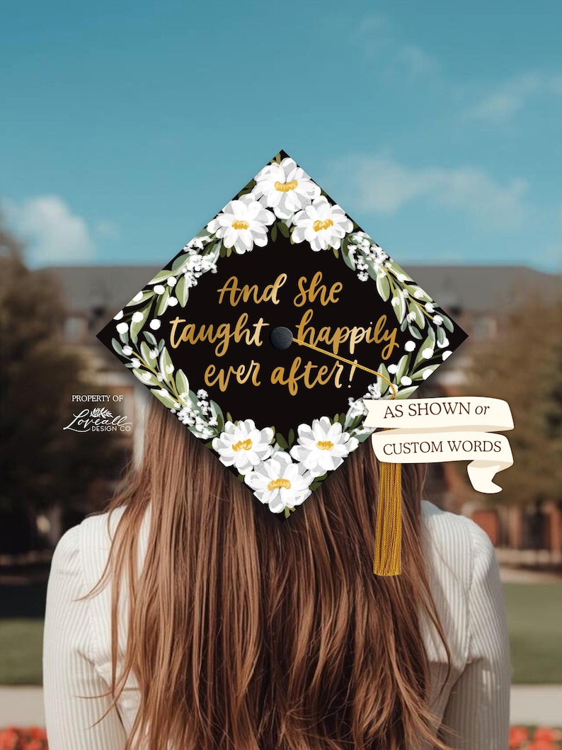 A person with long brown hair wearing a graduation cap with a floral design and text on it.