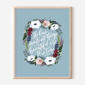 May include: A blue floral print with a white quote that reads "He has made all things beautiful in His time" - Ecclesiastes 3:11.