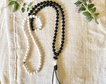 yin yang mala for balance and harmony. white howlite/black onyx/raw tourmaline. leather wrapped silk tassel. 108 beads/ spiritual meditation